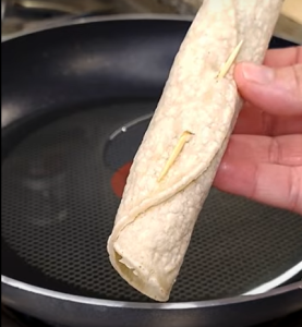 A Sealed Taco with Toothpick to Secure Filling