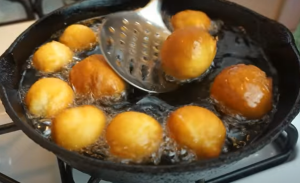 Frying Cinnabon Delight Balls in Dipped Oil