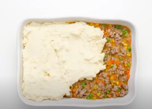 Spread Peas & Corn with Mashed Potatoes over the Lamb Mixture