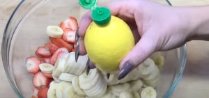 Spreading Lemon Juice over Strawberry and Banana Mixture