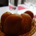 Basket of warm Texas Roadhouse copycat rolls with cinnamon honey butter