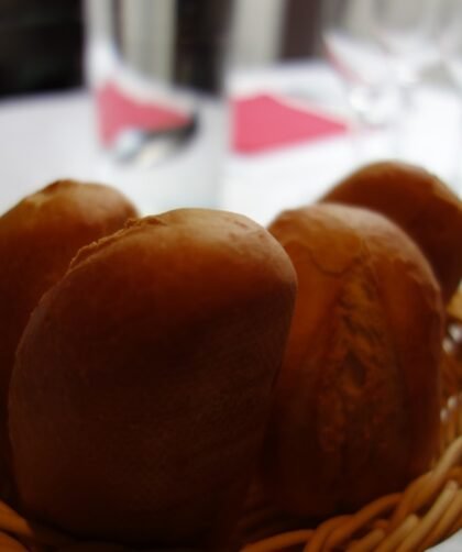 Basket of warm Texas Roadhouse copycat rolls with cinnamon honey butter